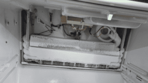 technician repairing Refrigerator Not Cooling Properly